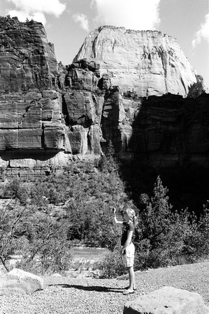 girl with camera in front of great white throne, zion np, utah